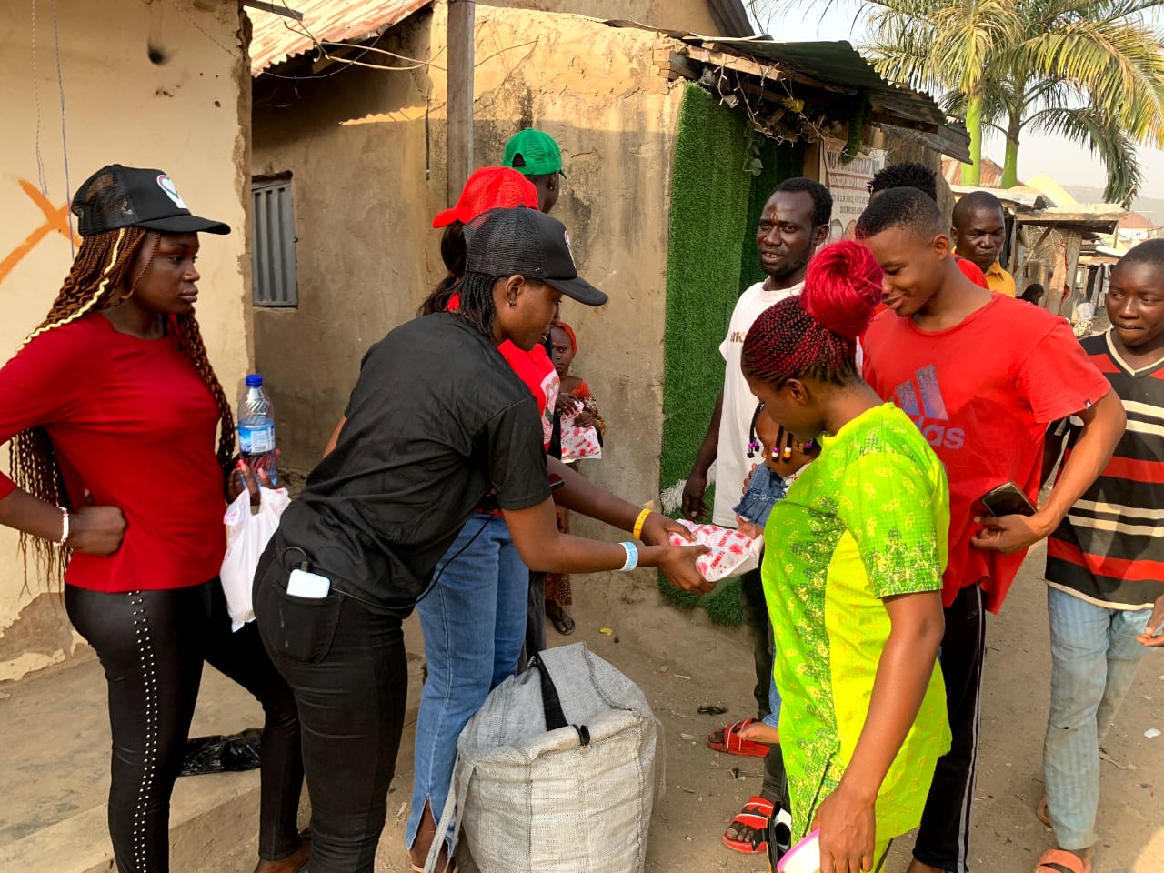 Volunteers preparing and handing out relief packs to community members during the Community Relief Day