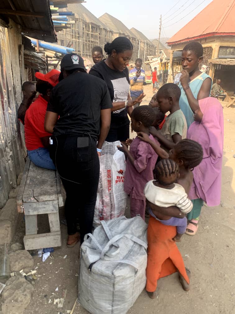 Foundation volunteers distributing large bags of rice and relief supplies to families during a community outreach day