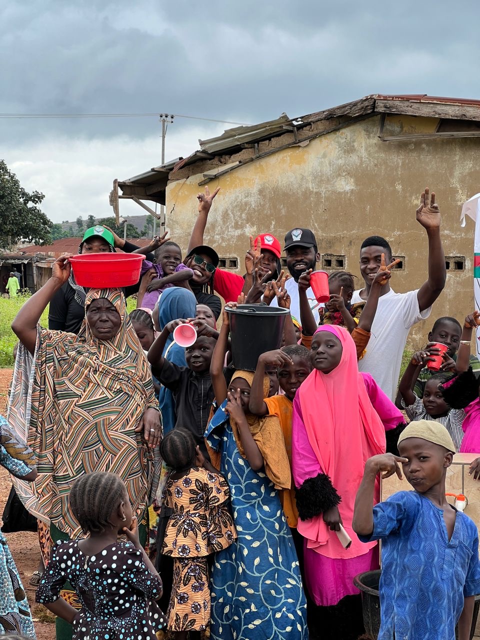 Community members and volunteers completing a village water point together