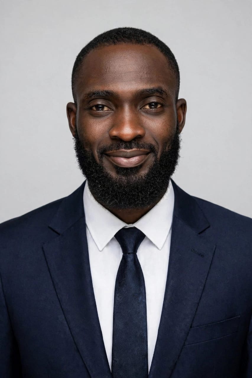 Portrait of Engr. Aliyu Taofeeq A., Project Manager of Halimat Humanitarian Foundation, in a navy suit and tie